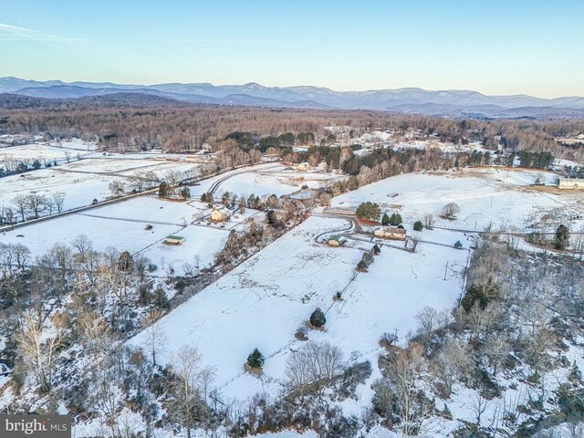 snowy aerial view featuring a mountain view