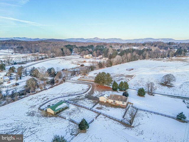 snowy aerial view with a mountain view