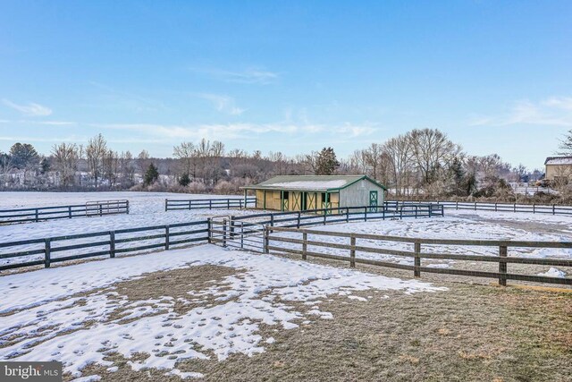 yard covered in snow with a rural view