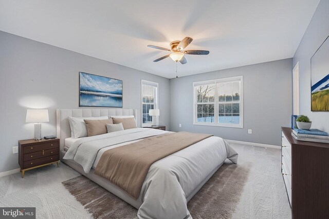 bedroom featuring light carpet and ceiling fan