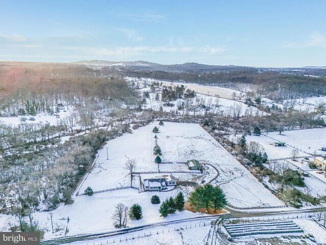 snowy aerial view with a mountain view