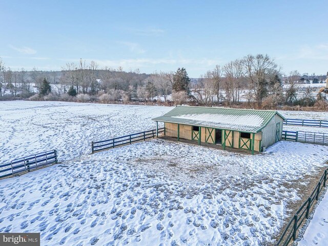 snowy yard with an outbuilding