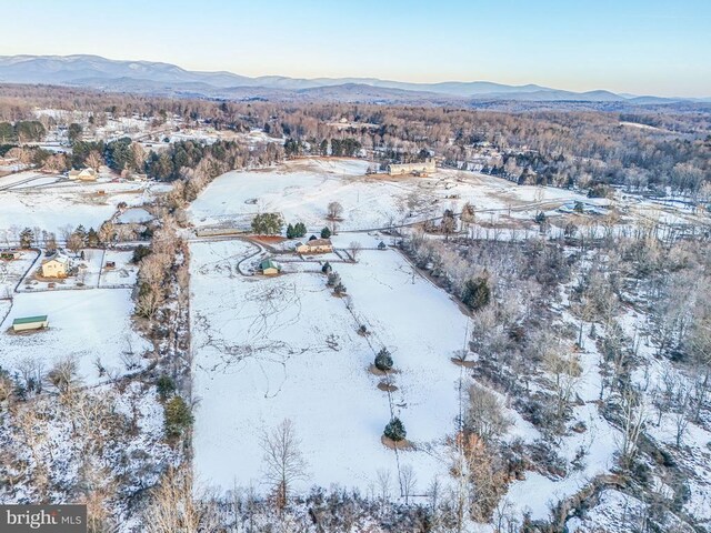 snowy aerial view with a mountain view