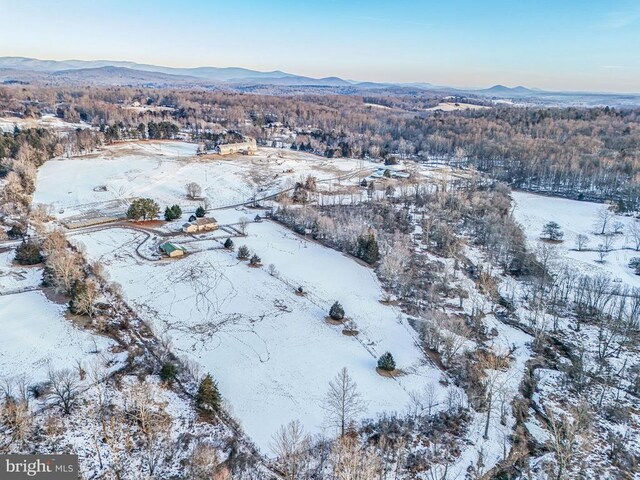 snowy aerial view with a mountain view