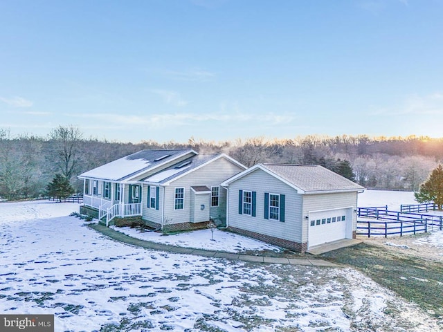 single story home featuring a garage and covered porch