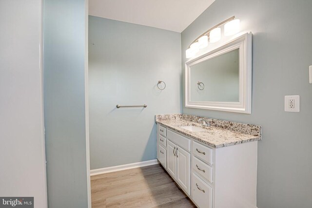 bathroom featuring vanity and hardwood / wood-style floors