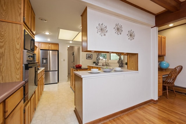 616 Lynn Ln, Waynesboro, VA 22980 - kitchen with black oven, stainless steel refrigerator with ice dispenser, a peninsula, recessed lighting, and light countertops