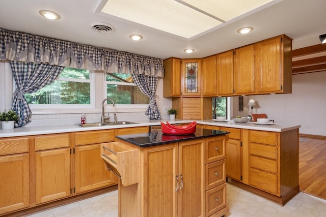 616 Lynn Ln, Waynesboro, VA 22980 - kitchen featuring a kitchen island, recessed lighting, glass insert cabinets, brown cabinetry, and light flooring