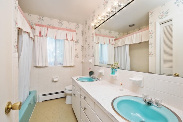 616 Lynn Ln, Waynesboro, VA 22980 - full bath featuring a baseboard heating unit, wallpapered walls, double vanity, tile walls, and wainscoting