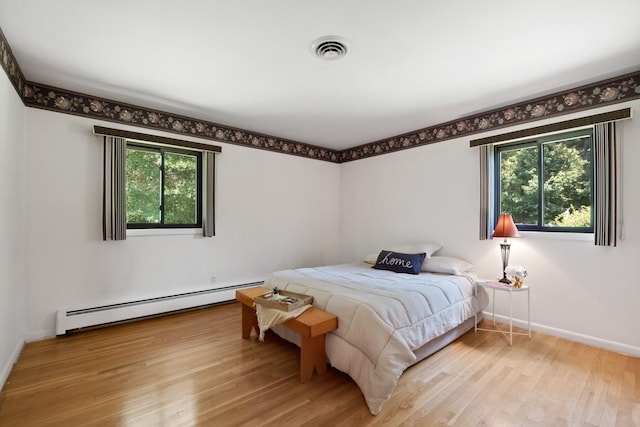 616 Lynn Ln, Waynesboro, VA 22980 - bedroom with a baseboard heating unit and wood finished floors