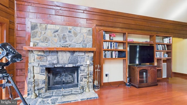 974 Cross Mountain Rd, Luray, VA 22835 - living area with baseboards, wooden walls, a fireplace, and wood finished floors