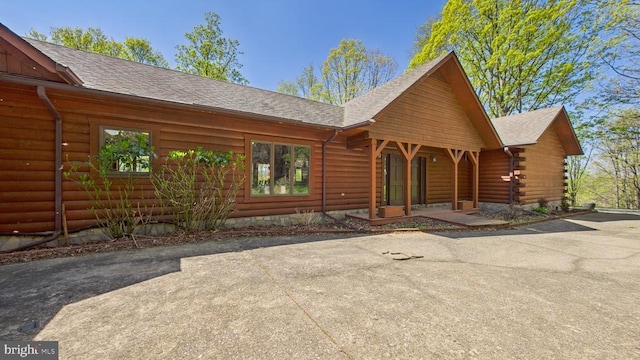 974 Cross Mountain Rd, Luray, VA 22835 - view of front of home featuring log siding, aphalt driveway, a patio area, and a shingled roof