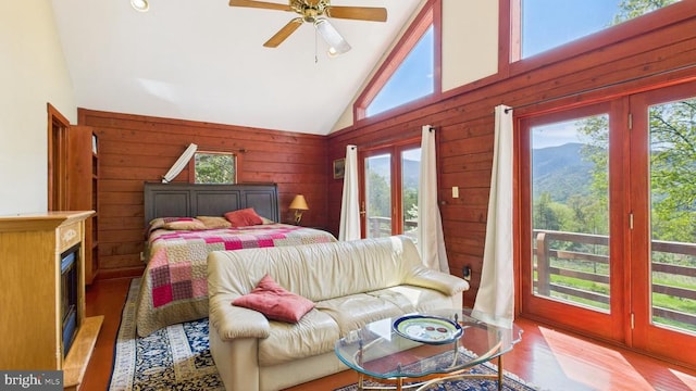 974 Cross Mountain Rd, Luray, VA 22835 - bedroom featuring high vaulted ceiling, access to outside, wood finished floors, and wooden walls