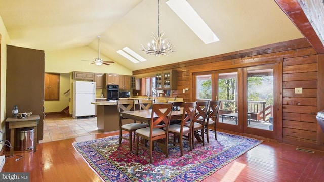 974 Cross Mountain Rd, Luray, VA 22835 - dining space with high vaulted ceiling, a skylight, light wood-type flooring, visible vents, and wooden walls