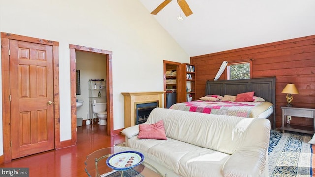 974 Cross Mountain Rd, Luray, VA 22835 - bedroom with wood walls, ensuite bathroom, wood finished floors, high vaulted ceiling, and a fireplace