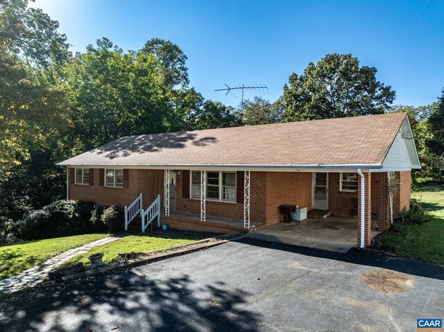1704 Old Brook Rd Unit 1700, Charlottesville, VA 22901 - ranch-style home with brick siding, a porch, a front yard, an attached carport, and aphalt driveway
