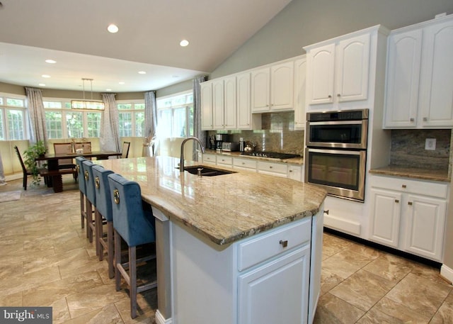 7308 Glenhaven Dr, Fredericksburg, VA 22407 - kitchen featuring stainless steel double oven, white cabinetry, light stone counters, backsplash, and recessed lighting