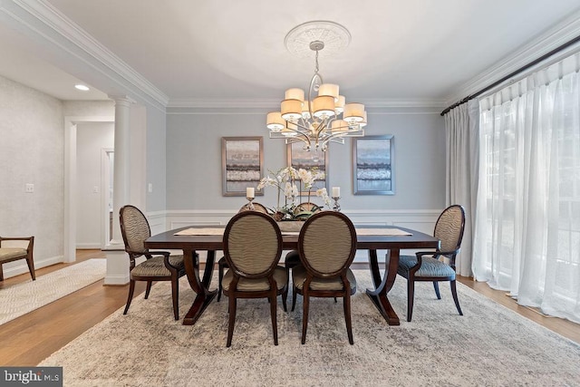 7308 Glenhaven Dr, Fredericksburg, VA 22407 - dining space with a chandelier, crown molding, wood finished floors, and a wainscoted wall