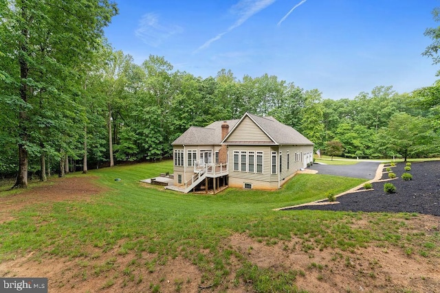 7308 Glenhaven Dr, Fredericksburg, VA 22407 - rear view of property featuring a chimney, a yard, a wooden deck, a view of trees, and stairs
