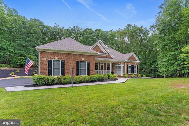7308 Glenhaven Dr, Fredericksburg, VA 22407 - view of front facade with brick siding, a porch, a front yard, and a shingled roof