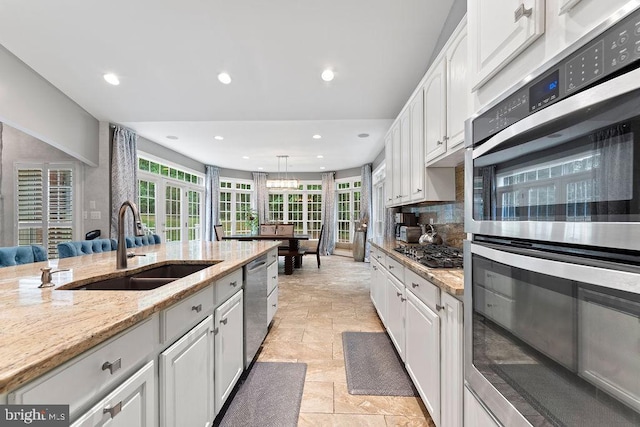 7308 Glenhaven Dr, Fredericksburg, VA 22407 - kitchen with appliances with stainless steel finishes, recessed lighting, white cabinetry, decorative backsplash, and light stone counters