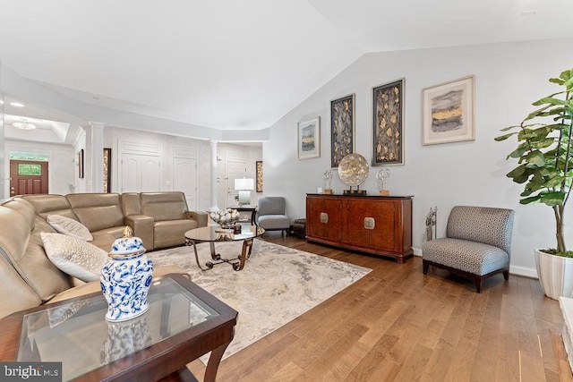 7308 Glenhaven Dr, Fredericksburg, VA 22407 - living area with ornate columns, wood finished floors, and vaulted ceiling