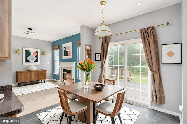 11106 Polaris Ct, Fredericksburg, VA 22407 - tiled dining room featuring baseboards and a fireplace with flush hearth