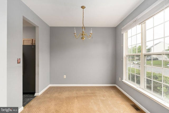 11106 Polaris Ct, Fredericksburg, VA 22407 - unfurnished room featuring a chandelier, healthy amount of natural light, light colored carpet, and baseboards