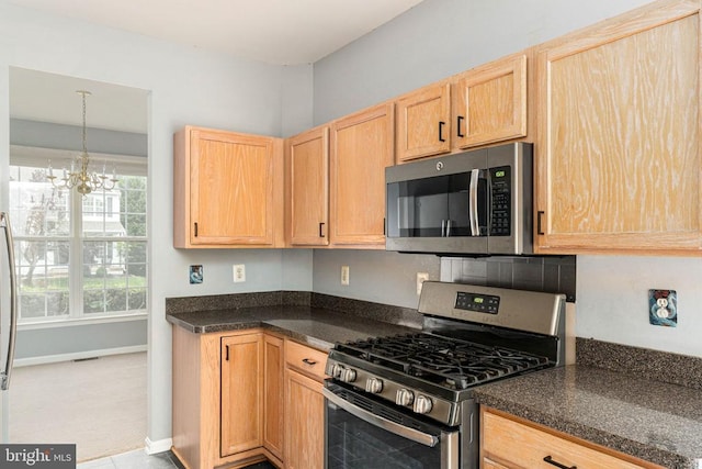 11106 Polaris Ct, Fredericksburg, VA 22407 - kitchen featuring stainless steel appliances, light brown cabinets, dark countertops, a chandelier, and baseboards