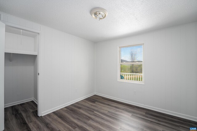 817 Brownings Cv, Shipman, VA 22971 - unfurnished bedroom featuring dark wood-style flooring, a textured ceiling, baseboards, and a closet