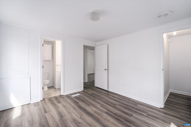 817 Brownings Cv, Shipman, VA 22971 - unfurnished bedroom with wood finished floors, baseboards, and ensuite bath
