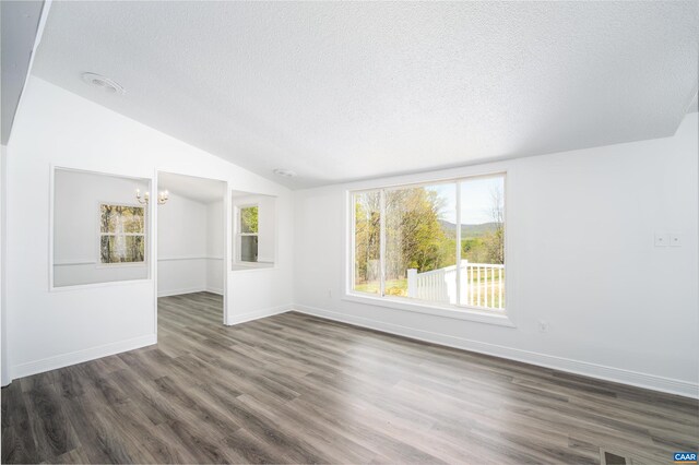 817 Brownings Cv, Shipman, VA 22971 - empty room with a textured ceiling, vaulted ceiling, wood finished floors, a chandelier, and baseboards