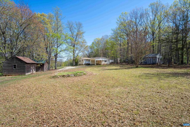 817 Brownings Cv, Shipman, VA 22971 - view of green lawn featuring an outdoor structure and a carport