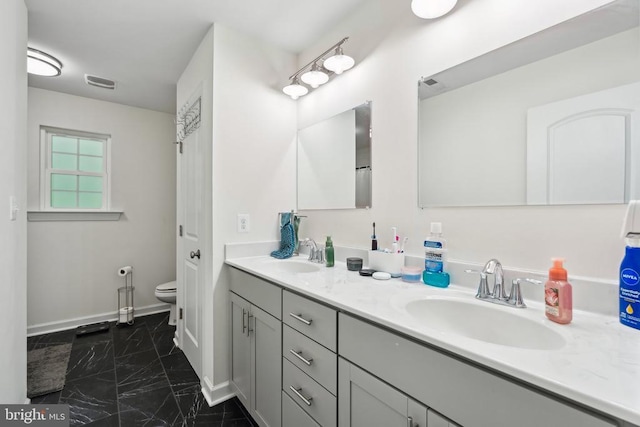 12811 Flintlock Dr, Spotsylvania, VA 22551 - bathroom featuring marble finish flooring, double vanity, baseboards, and toilet