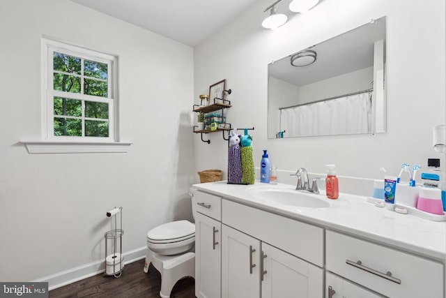 12811 Flintlock Dr, Spotsylvania, VA 22551 - full bathroom with vanity, toilet, wood finished floors, and baseboards