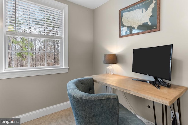 office area featuring light colored carpet and baseboards