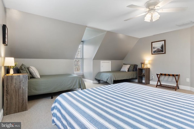 bedroom featuring light colored carpet, visible vents, a ceiling fan, vaulted ceiling, and baseboards