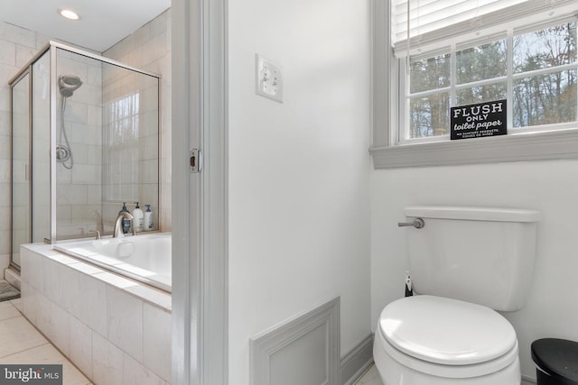 bathroom with tile patterned flooring, a garden tub, toilet, and a shower stall