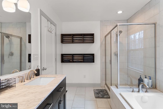 bathroom featuring a garden tub, vanity, baseboards, tile patterned floors, and a stall shower