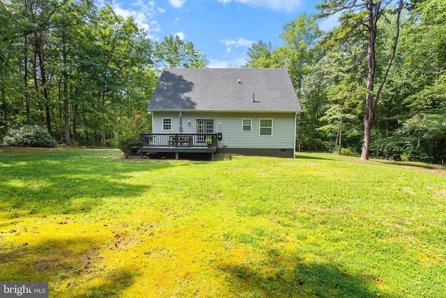 back of property featuring a deck, roof with shingles, crawl space, and a lawn