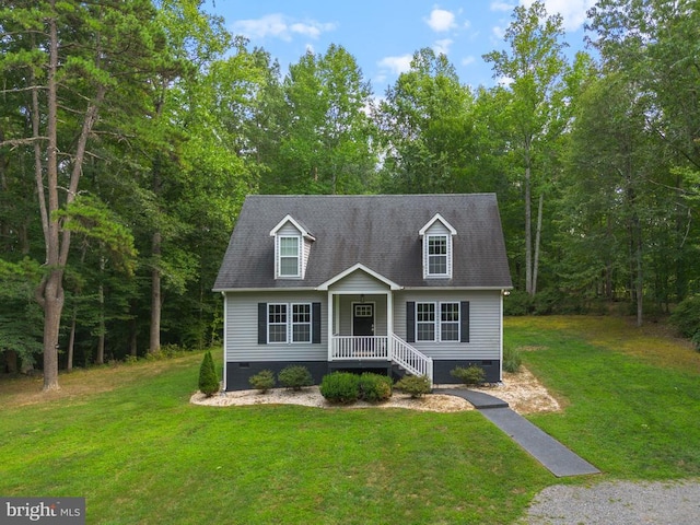 new england style home with crawl space, a front lawn, and roof with shingles