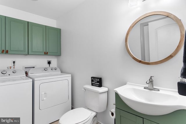 bathroom featuring toilet, vanity, and independent washer and dryer