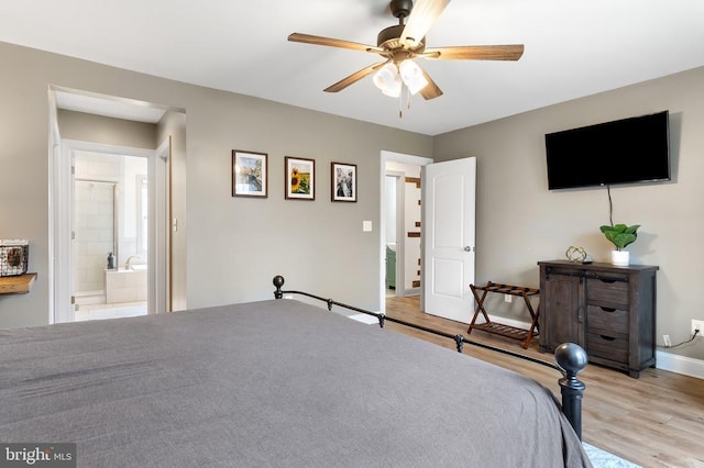 bedroom featuring ceiling fan, light wood finished floors, ensuite bath, and baseboards