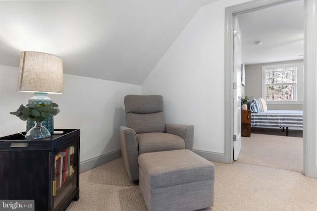 sitting room featuring carpet floors, lofted ceiling, and baseboards