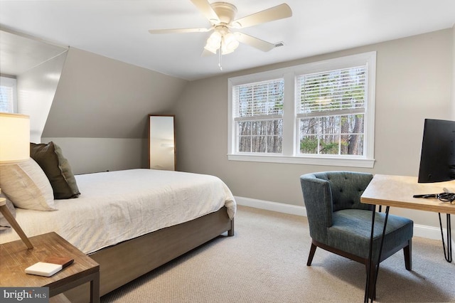 bedroom with lofted ceiling, visible vents, baseboards, and light colored carpet