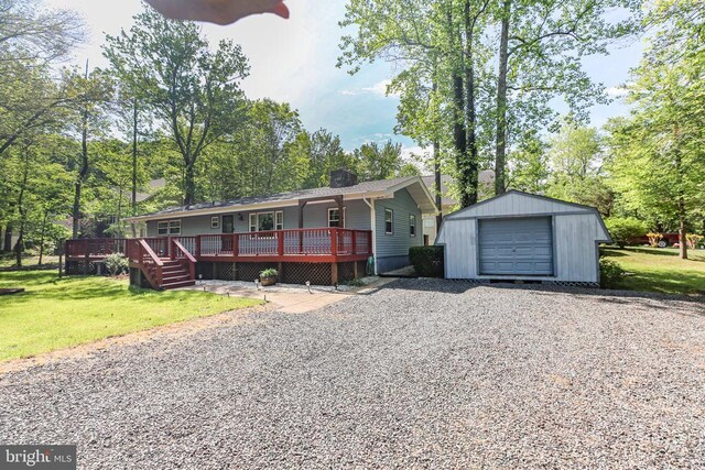 100 Musket Ln, Locust Grove, VA 22508 - single story home featuring an outbuilding, gravel driveway, a front lawn, a deck, and a garage
