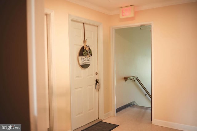 doorway to outside featuring crown molding, baseboards, and light floors