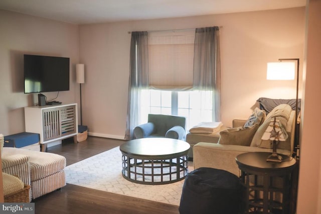 living room featuring wood finished floors and baseboards