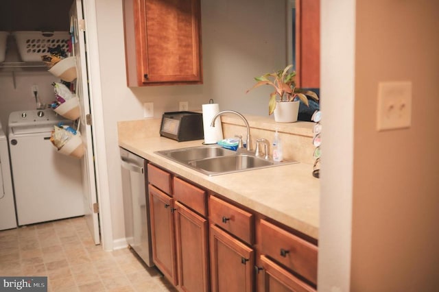 kitchen with washing machine and dryer, dishwasher, a sink, light countertops, and brown cabinets