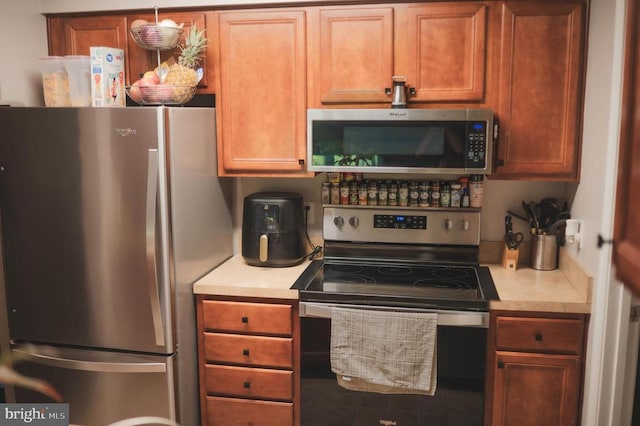 kitchen with appliances with stainless steel finishes and light countertops